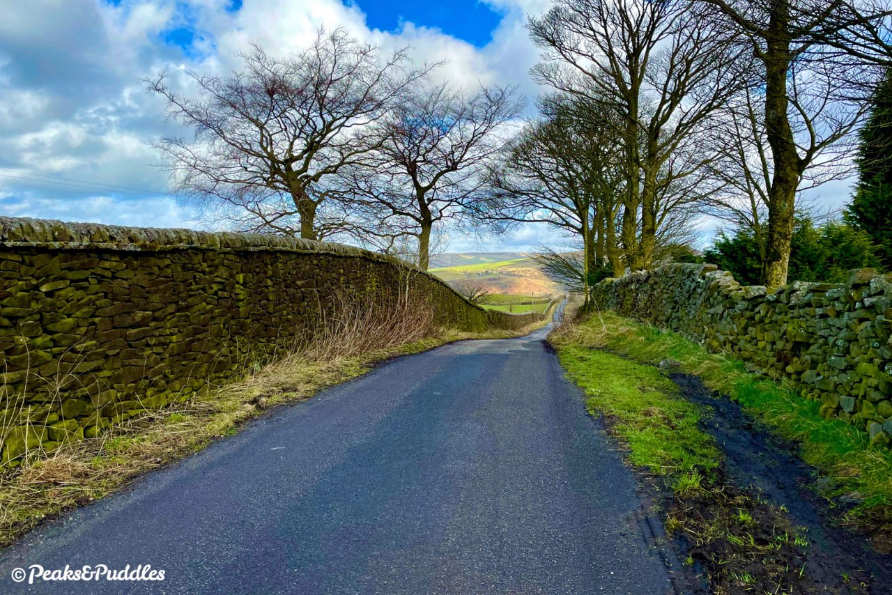 Looking back down the practically fortified Over Hill Road as the sun hits Lantern Pike and Cown Edge.